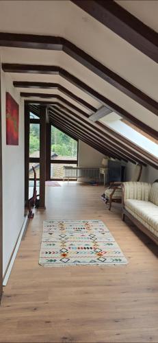 a living room with a couch and a rug at Wohnung im Schwarzwald mit Panorama Blick in Kleines Wiesental