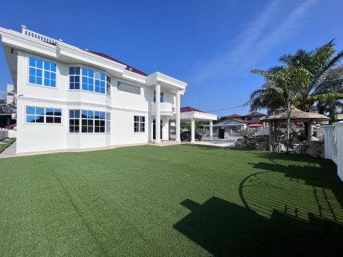 una gran casa blanca con un gran patio en DeGarden House Bangi, en Kajang
