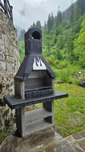 a stone oven with a pair of shoes on it at Villa Molin Del Faure in Alleghe