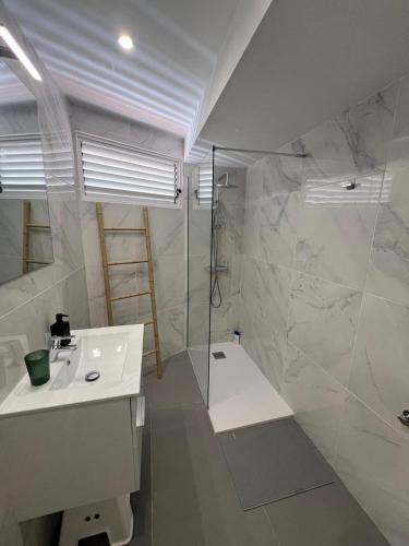 a bathroom with a shower and a sink and a tub at Tenerife sea view 216 in Playa Fañabe