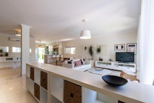 a large white kitchen with a large island in a living room at Altura Villa in Altura