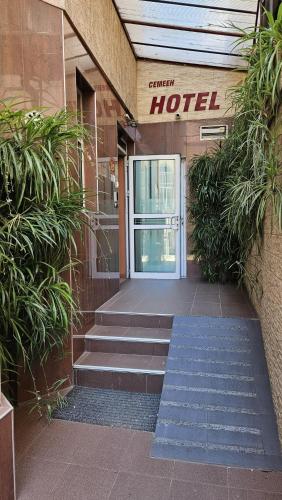 a hotel entrance with stairs leading to a door at Caprice Family Hotel in Varna City