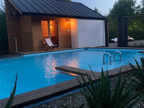a swimming pool in front of a house at Admiral Yacht in Świnoujście