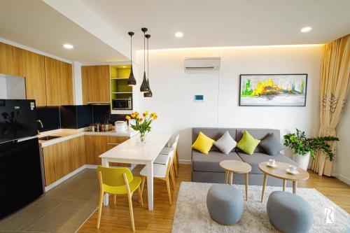 a kitchen and living room with a couch and a table at Republic Airport Apartment Free Swimming Pool in Ho Chi Minh City