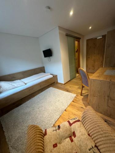 a room with a bed and a table and a couch at Landgasthof Hauser in Immendingen