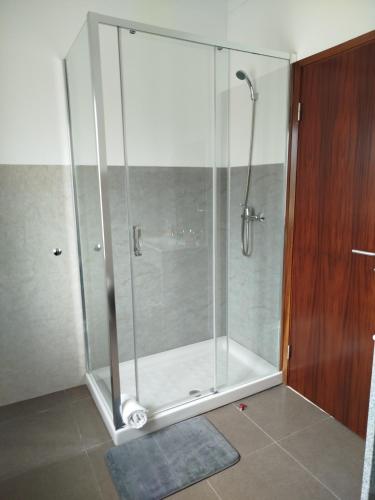 a shower with a glass enclosure in a bathroom at Casinha da Glória in Silva