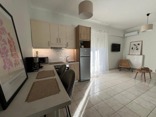 a kitchen and living room with a table and chairs at Joyful Guest Houses by 8essentially in Chania Town