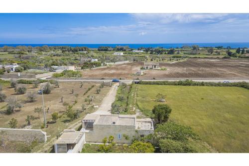 an aerial view of a house with the ocean in the background at Villa La Reimunda in Otranto