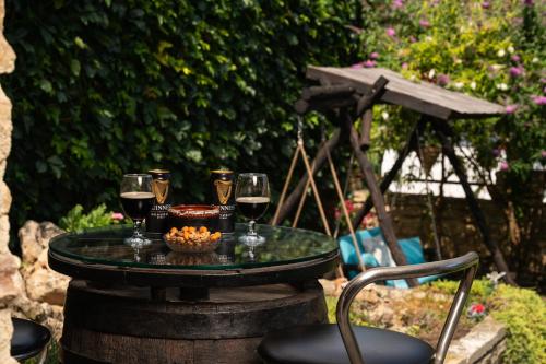 a table with glasses of wine and a bowl of food at Villa Komitata-Pool and Jacuzzi in Balchik