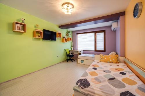 a bedroom with green and purple walls and a bed at Villa Komitata-Pool and Jacuzzi in Balchik