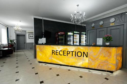 a yellow counter with the word reception on it at ALCAZAR in Atyraū
