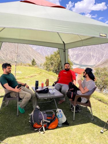 a group of people sitting under a tent at Cosy Camping Site Hapakun by Manokur- e- Basa in Minapin