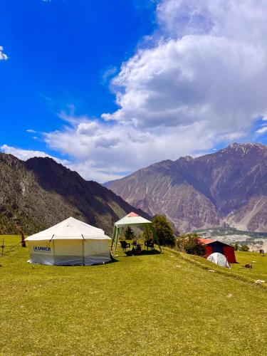 a tent in a field with mountains in the background at Cosy Camping Site Hapakun by Manokur- e- Basa in Minapin