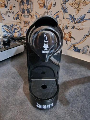 a black iron is sitting on the floor at Namastè Apartments Agrigento in Agrigento