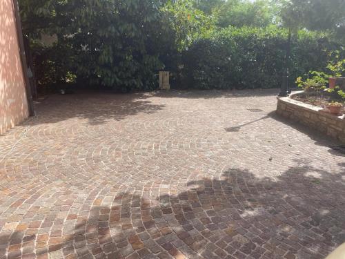 a brick patio with a shadow on the ground at A casa di Bia in Castro dei Volsci