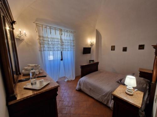 a bedroom with a bed and a dresser and a window at PALAZZO PALITTI in Poggio
