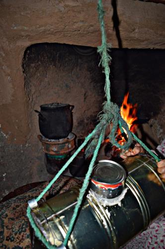 a stove with a pot and a fire at Atlas Pearl in Aguersioual