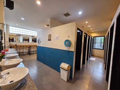 a bathroom with four sinks and a row of toilets at Mercy Hostel in Chiang Rai