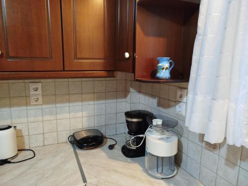 a kitchen counter with two appliances on a counter top at Barbara's Sea View Home in Benitses