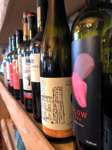 a row of bottles of wine on a shelf at Willa u Steni in Gliczarów
