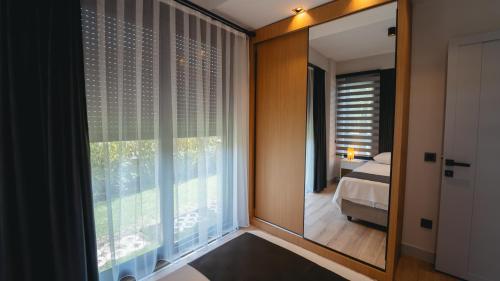 a bedroom with a mirror and a bed and a window at - Meta Homes - in Kemer