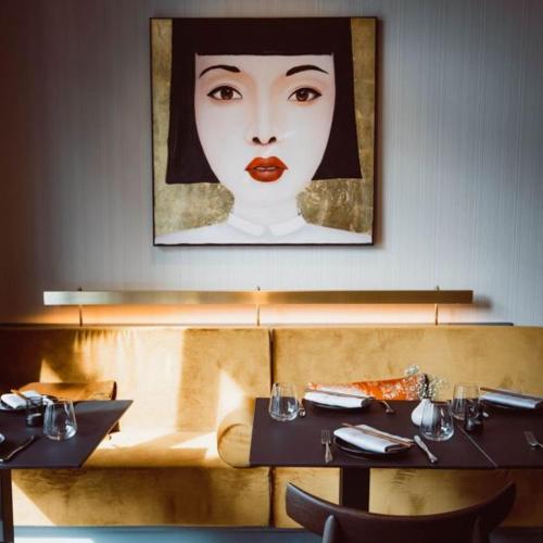 a restaurant with a picture of a woman with red lipstick at Velotel Bad Saarow in Bad Saarow