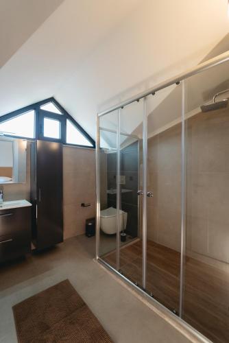 a bathroom with a glass shower and a toilet at - Meta Homes - in Kemer