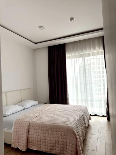a bedroom with a bed and a large window at Blue Sutomore in Brca