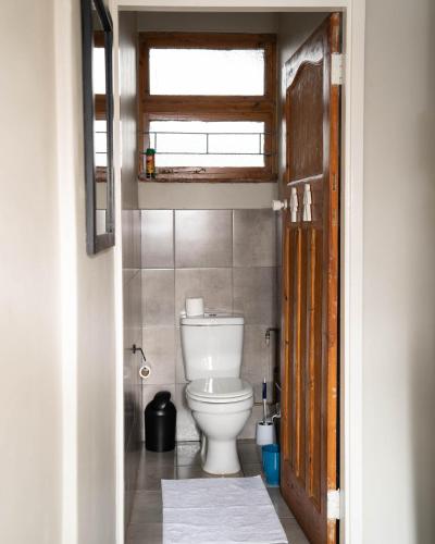 a bathroom with a white toilet in a room at Patterson B&B in Newcastle