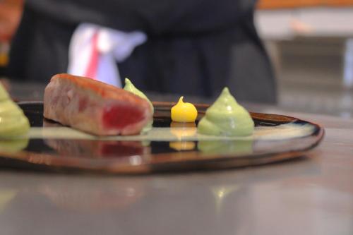 a plate with a piece of food on a table at Bella Vista Hôtel, Suites & Maisons in Porticcio