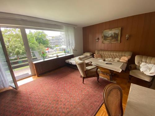 a living room with a table and a couch at Apartment "Wirtschaftswunder" in Rheinfelden