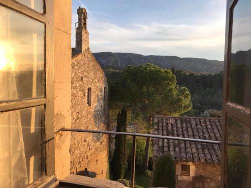 a view from a window of an old building at La Maison Joly in Ménerbes