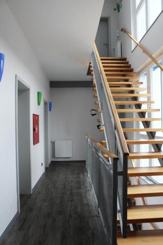 a staircase in an empty room with wooden stairs at Pension Escrime in Karlovy Vary