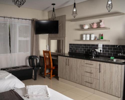 a kitchen with a sink and a counter top at Patterson B&B in Newcastle