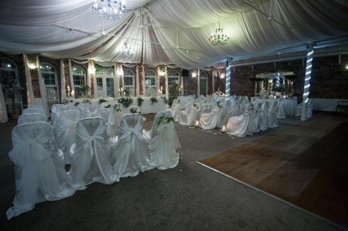 a row of wedding chairs in a marquee at Meifod House in Caernarfon