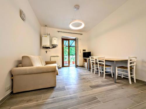 a living room with a couch and a table and chairs at Residence La Poggerina in Figline Valdarno