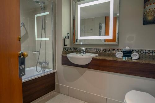 a bathroom with a sink and a mirror at Slaley Hall Hotel, Spa & Golf Resort in Slaley