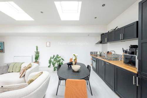 une cuisine et un salon avec un canapé et une table dans l'établissement Coeur des Chartrons, à Bordeaux