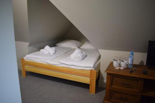 a bed with white sheets and pillows in a room at Panorama Premium in Kościelisko