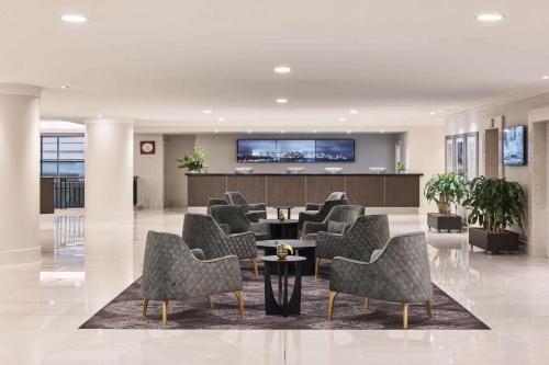 a lobby with chairs and a waiting room at Rydges World Square in Sydney