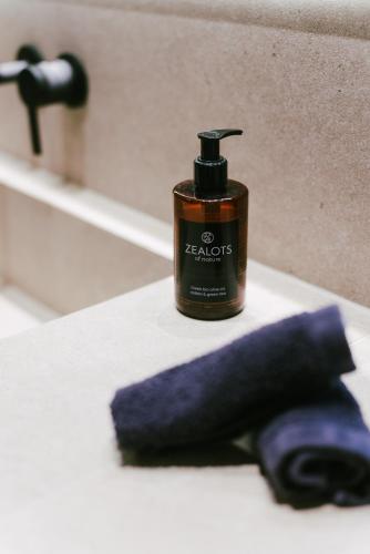 a bottle of hand lotion sitting on a bathroom sink at LAN-GO SIVOTA Luxury Living in Sivota