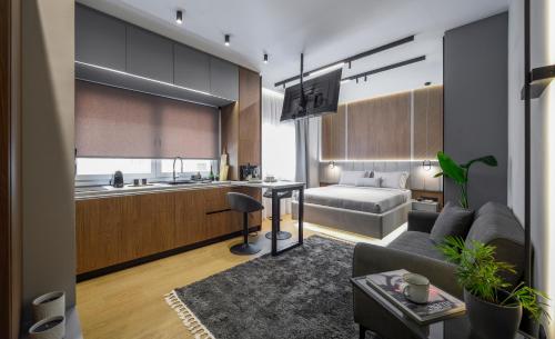 a living room with a couch and a kitchen at Aristotelian Virtues - Tharros in Thessaloniki