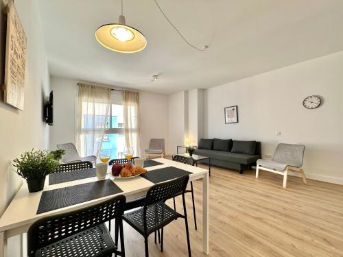 a living room with a table and chairs and a couch at Sunny Seas Hideaway Apartment in Los Abrigos