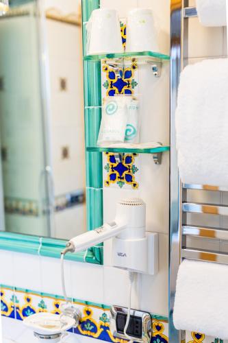 a bathroom with a mirror and towels at Il Principe Resort in Agerola