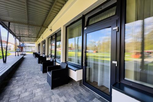 a row of benches in a building with windows at WHITE HOUSE in Jastrzębia Góra