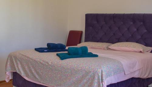 a bed with two blue towels on top of it at Villa Dulsinea in Ulcinj