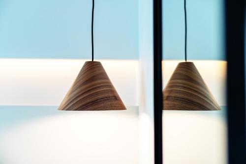 a pair of lights hanging in a room at Domes White Coast Milos, Adults Only - Small Luxury Hotels of the World in Mytakas