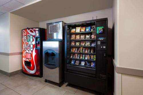 a refrigerator and a soda machine in a store at Country Inn & Suites by Radisson, Marion, IL in Marion