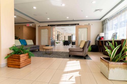 an office lobby with chairs and a couch and a table at Gateway Hotel & Suites, an Ascend Collection Hotel in Ocean City