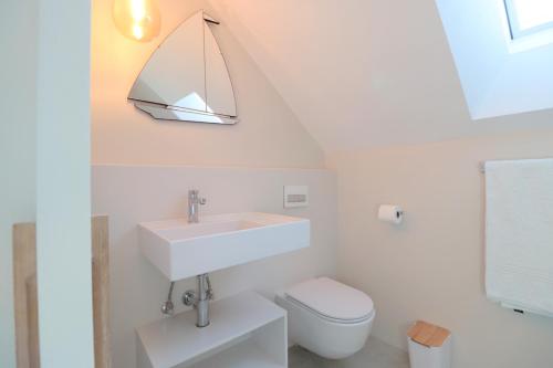 a bathroom with a sink and a toilet at Kestrel Apartments in Paternoster